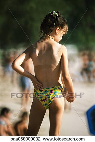 Bare-chested girl on beach, rear view View Large Photo Image Stock Image - Bare-chested girl on beach, rear view. Fotosearch