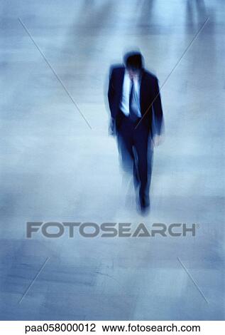 Businessman walking, high angle view, blurred View Large Photo Image Stock Image - Businessman walking, high angle view, blurred. Fotosearch