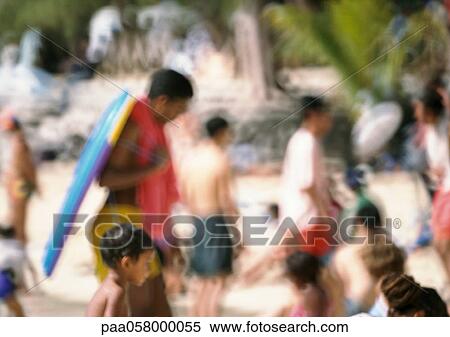 Stock Photography - Crowd on beach, blurred. Fotosearch