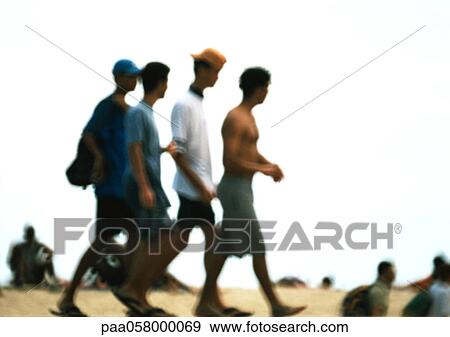 Stock Photo - Four men walking, side view, blurred. Fotosearch