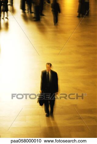 Stock Image - Man holding briefcase, high angle view. Fotosearch