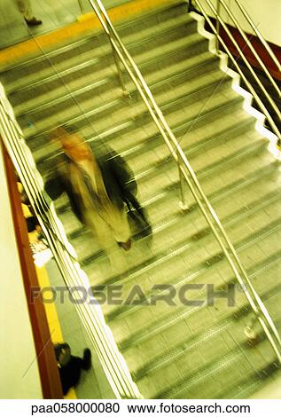 Man on stairs, high angle view, blurred View Large Photo Image Stock Image - Man on stairs, high angle view, blurred. Fotosearch