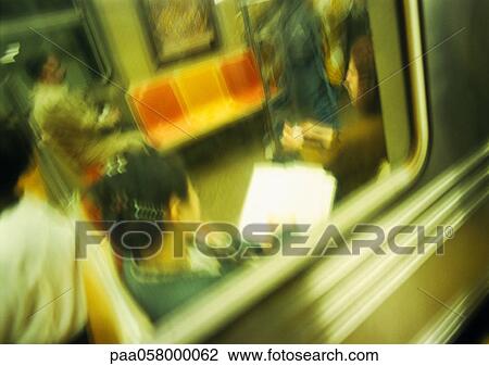 Stock Image - People in subway, viewed from outside, blurred. Fotosearch