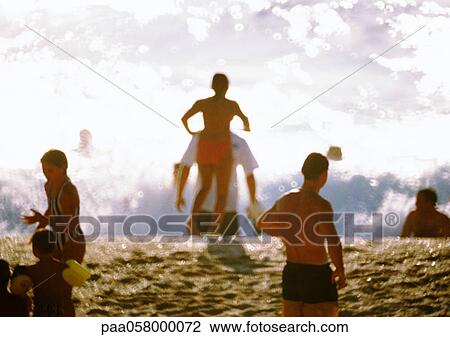 People on beach, waves in background View Large Photo Image Stock Image - People on beach, waves in background. Fotosearch