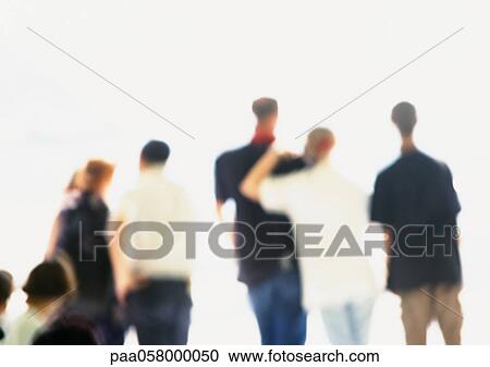 Stock Image - People standing side by side, rear view, blurred. Fotosearch