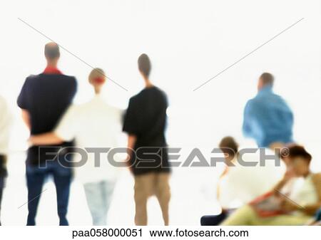 Stock Image - People standing side by side, rear view, defocused. Fotosearch