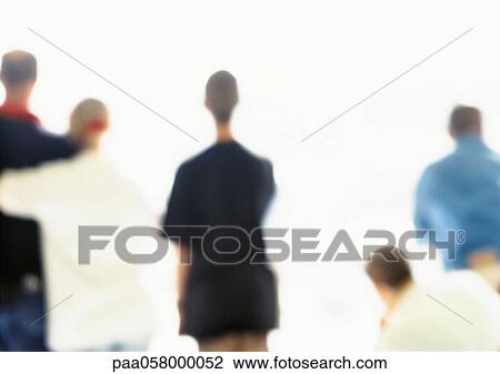 Stock Image - People standing side by side, rear view, blurred. Fotosearch