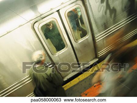 Person waiting in front of subway doors, high angle view, blurred View Large Photo Image Stock Image - Person waiting in front of subway doors, high angle view, blurred. Fotosearch