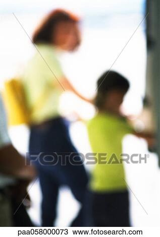 Stock Image - Silhouettes of woman and child, blurred. Fotosearch