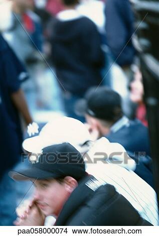 Three people sitting, high angle view, blurred View Large Photo Image Picture - Three people sitting, high angle view, blurred. Fotosearch