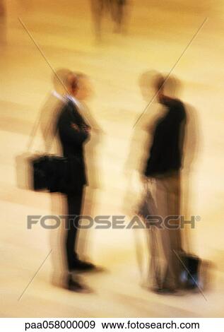 Two men standing in concourse, blurred View Large Photo Image Stock Photo - Two men standing in concourse, blurred. Fotosearch