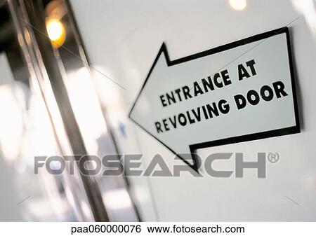 Entrance at revolving door text on arrow sign, close-up View Large Illustration Stock Illustration - Entrance at revolving door text on arrow sign, close-up. Fotosearch