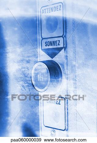 Stock Illustration - Security entrance button, with "wait, ring, here, enter" text in French, close-up. Fotosearch