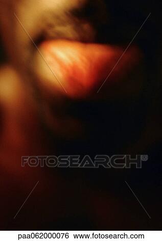 Man sticking tongue out, close up, blurred. View Large Photo Image Stock Photograph - Man sticking tongue out, close up, blurred.. Fotosearch