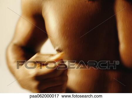 Stock Photo - Man's bare chest and fist, close up, blurred.. Fotosearch