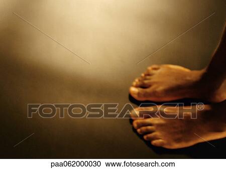 Stock Image - Man's bare feet, view from above.. Fotosearch