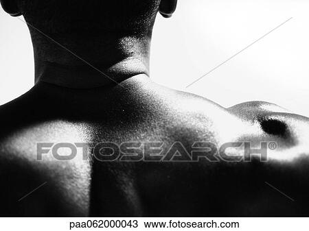 Stock Image - Man's neck and shoulder, close up, view from behind, black and white.. Fotosearch