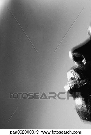 Stock Photo - Man's nose and mouth, view from side, close up, black and white.. Fotosearch