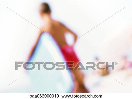Boy holding boogie board on beach, blurred View Large Photo Image Stock Photo - Boy holding boogie board on beach, blurred. Fotosearch