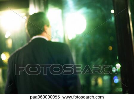 Business man, rear view, with glare of lights, blurred. View Large Photo Image Stock Photography - Business man, rear view, with glare of lights, blurred.. Fotosearch