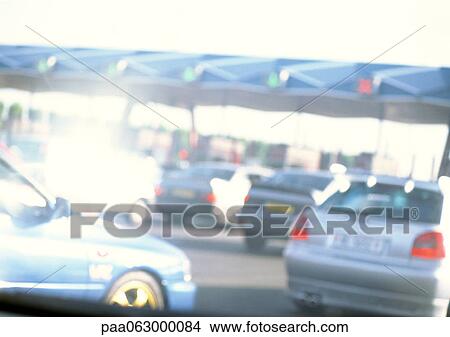 Cars waiting at toll booth, blurred View Large Photo Image Picture - Cars waiting at toll booth, blurred. Fotosearch