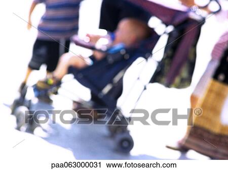Child in stroller with group of people, blurred View Large Photo Image Stock Image - Child in stroller with group of people, blurred. Fotosearch