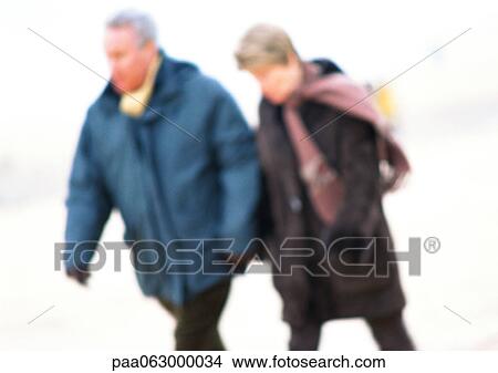 Man and woman walking together, blurred and faded. View Large Photo Image Picture - Man and woman walking together, blurred and faded.. Fotosearch