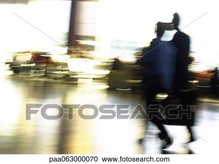Stock Image - People in airport, blurred. Fotosearch