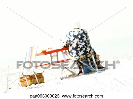 Person at the beach, rear view, blurred View Large Photo Image Stock Image - Person at the beach, rear view, blurred. Fotosearch