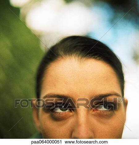 Stock Image - Partial view of woman's face looking up, close up, portrait.. Fotosearch