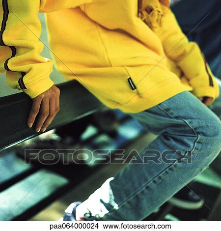 Picture - Teenager sitting on rail.. Fotosearch