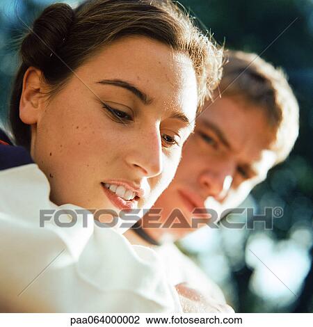 Stock Image - Young couple outside, close-up. Fotosearch