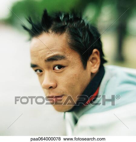 Stock Photo - Young man looking at camera, close-up, portrait.. Fotosearch