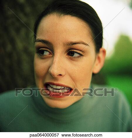 Stock Photo - Young woman making face, close-up, portrait.. Fotosearch