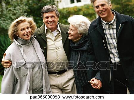 Four mature people walking together View Large Photo Image Stock Image - Four mature people walking together. Fotosearch