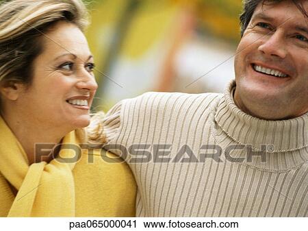 Man and woman embracing, smiling, head and shoulders, out of frame, close-up View Large Photo Image Stock Image - Man and woman embracing, smiling, head and shoulders, out of frame, close-up. Fotosearch