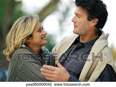 Stock Photography - Man and woman facing each other, side view, head and shoulders, close-up. Fotosearch
