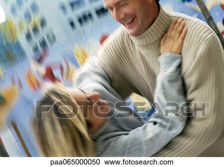 Stock Image - Man and woman holding each other, blurred. Fotosearch