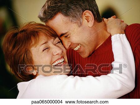 Man and woman hugging, smiling, close up. View Large Photo Image Picture - Man and woman hugging, smiling, close up.. Fotosearch