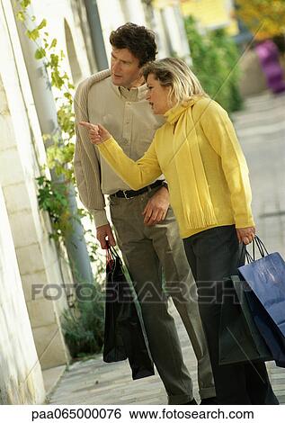 Man and woman looking in store window, side view, full length View Large Photo Image Stock Photograph - Man and woman looking in store window, side view, full length. Fotosearch