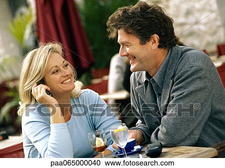 Man and woman sitting at table, head and shoulders View Large Photo Image Stock Image - Man and woman sitting at table, head and shoulders. Fotosearch