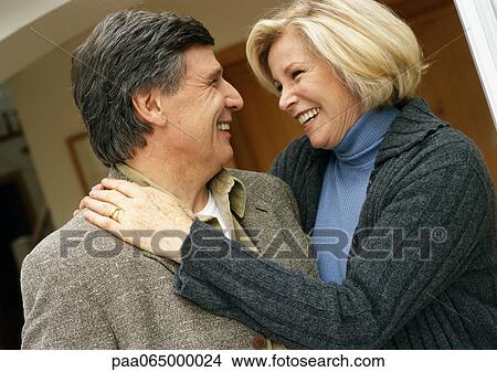 Man and woman smiling face to face, woman with arms around man, head and shoulders, close-up View Large Photo Image Picture - Man and woman smiling face to face, woman with arms around man, head and shoulders, close-up. Fotosearch
