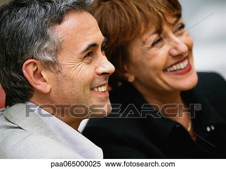 Man and woman smiling, side by side, close up. View Large Photo Image Stock Photography - Man and woman smiling, side by side, close up.. Fotosearch