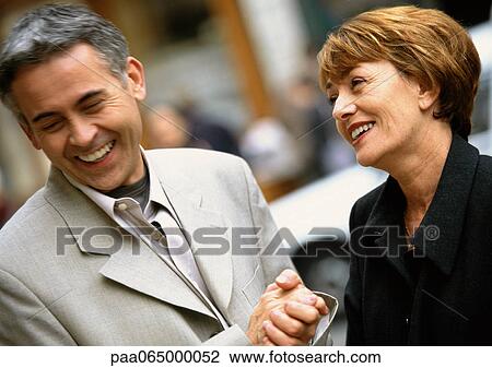 Man and woman standing laughing together, woman looking at man, close up. View Large Photo Image Stock Image - Man and woman standing laughing together, woman looking at man, close up.. Fotosearch