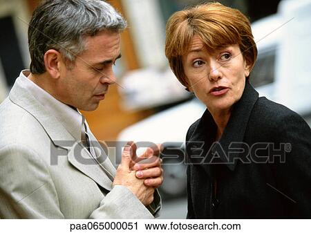 Man and woman standing together looking in different directions, head and shoulders View Large Photo Image Stock Image - Man and woman standing together looking in different directions, head and shoulders. Fotosearch