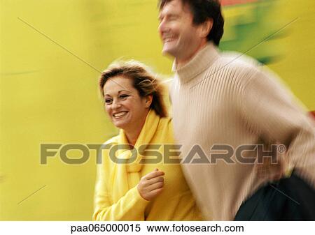 Stock Photography - Man and woman walking together, blurred. Fotosearch
