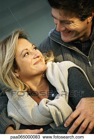 Man holding woman from behind, woman looking back at man, close up. View Large Photo Image Stock Image - Man holding woman from behind, woman looking back at man, close up.. Fotosearch