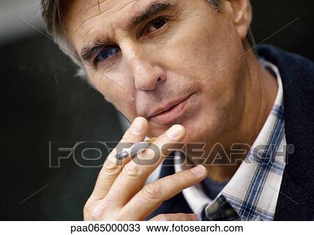 Man smoking cigarette, close up. View Large Photo Image Stock Image - Man smoking cigarette, close up.. Fotosearch