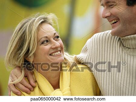 Man with arm around woman, head and shoulders, close-up View Large Photo Image Stock Image - Man with arm around woman, head and shoulders, close-up. Fotosearch