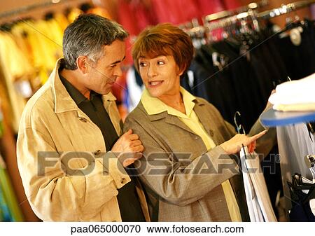 Mature man and woman in clothing store, waist up. View Large Photo Image Stock Image - Mature man and woman in clothing store, waist up.. Fotosearch